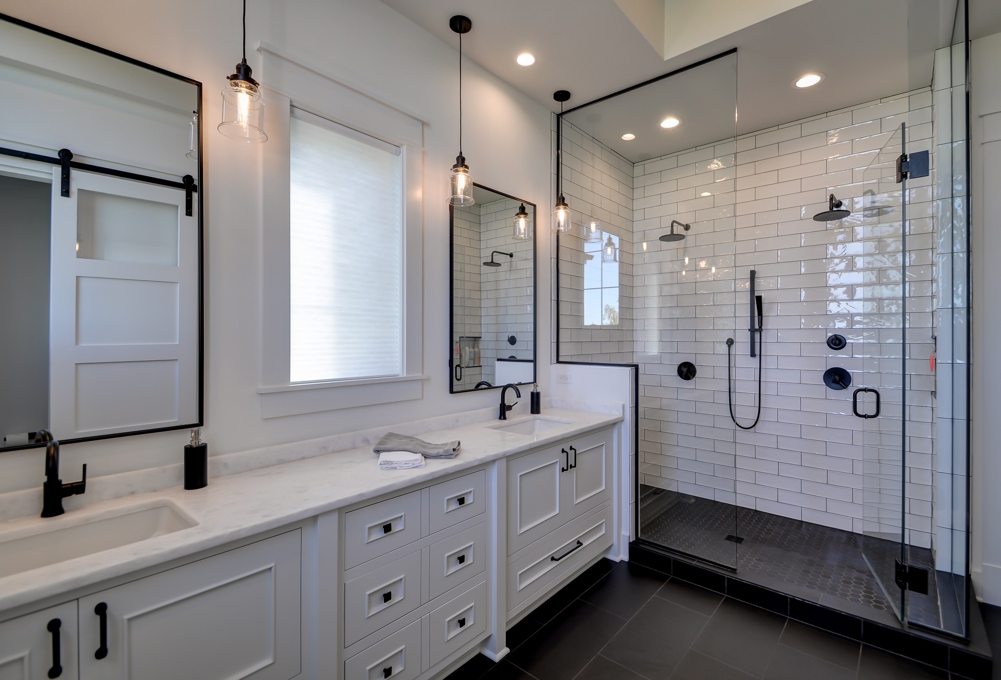 Modern bathroom with double vanity and walk-in shower.