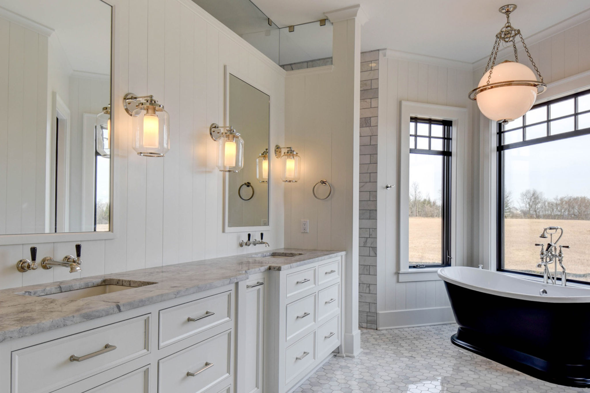 Elegant bathroom with a freestanding tub and dual vanity in a luxury custom home.