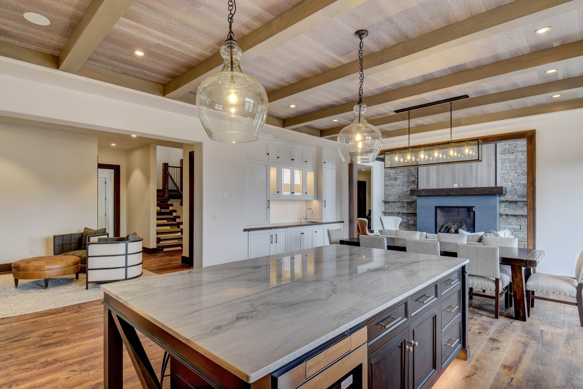 Spacious kitchen and dining area with high ceilings and modern fixtures, designed by a Luxury Custom Home Builder
