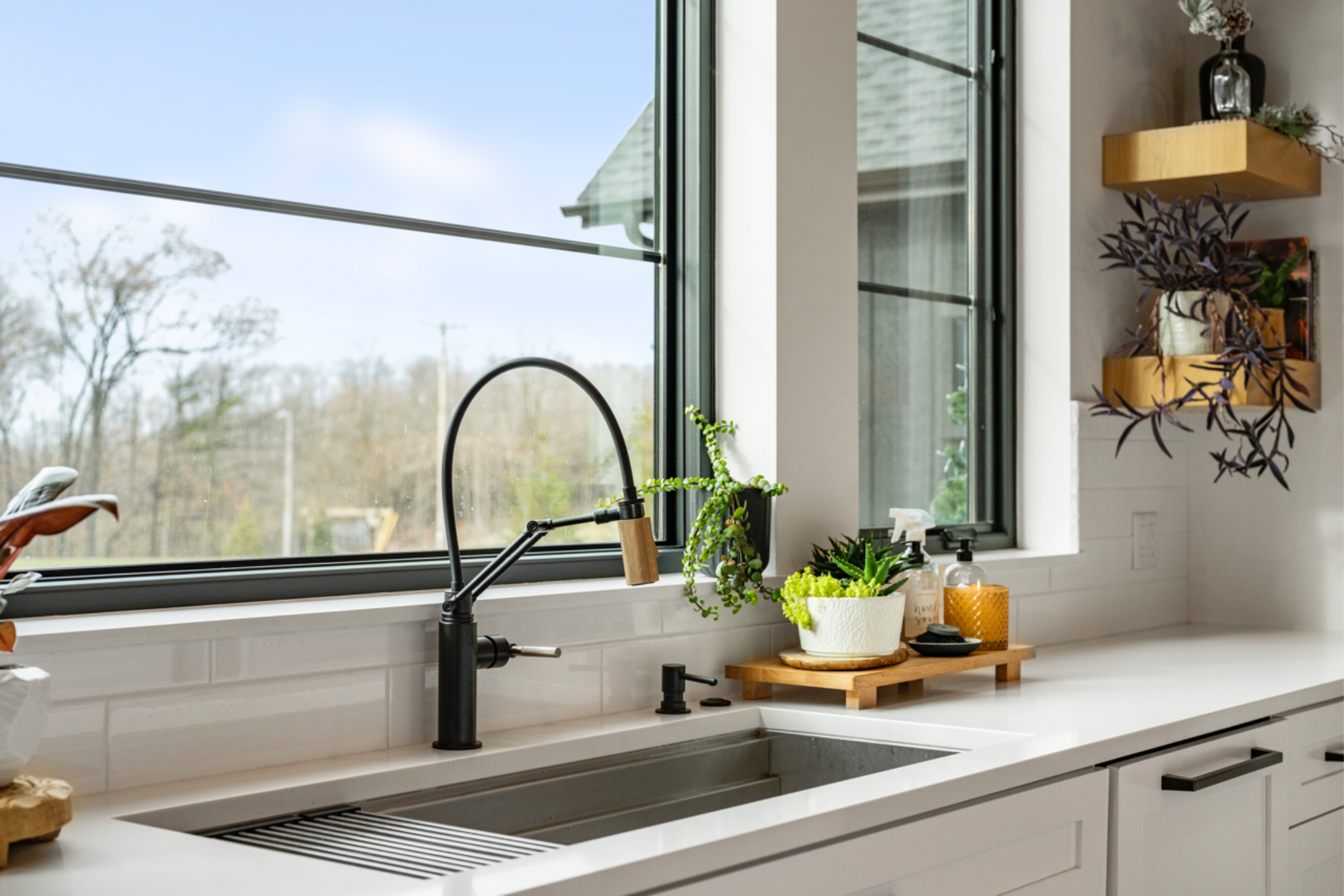 Bright kitchen sink area with quartz countertops, demonstrating one of the best countertop materials for durability and style.