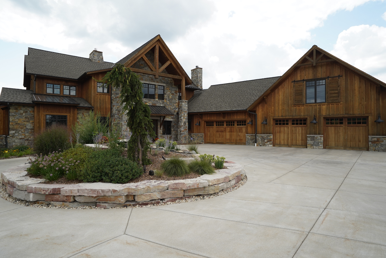 A beautiful example of luxury residential construction in Southeast Wisconsin, showcasing a stunning exterior with natural wood and stone finishes.