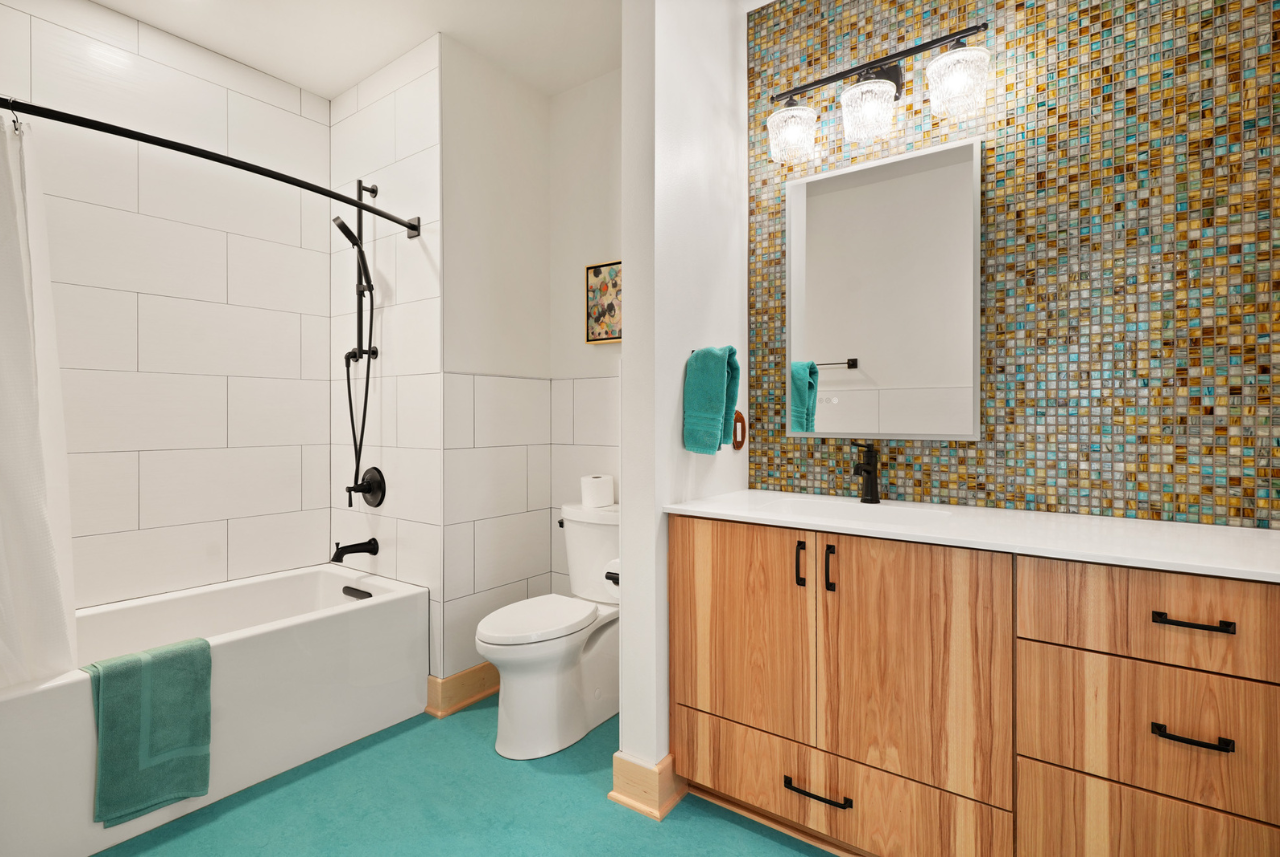 A modern bathroom crafted by home builders in Waukesha, WI, showcasing sleek tile work and stylish fixtures.