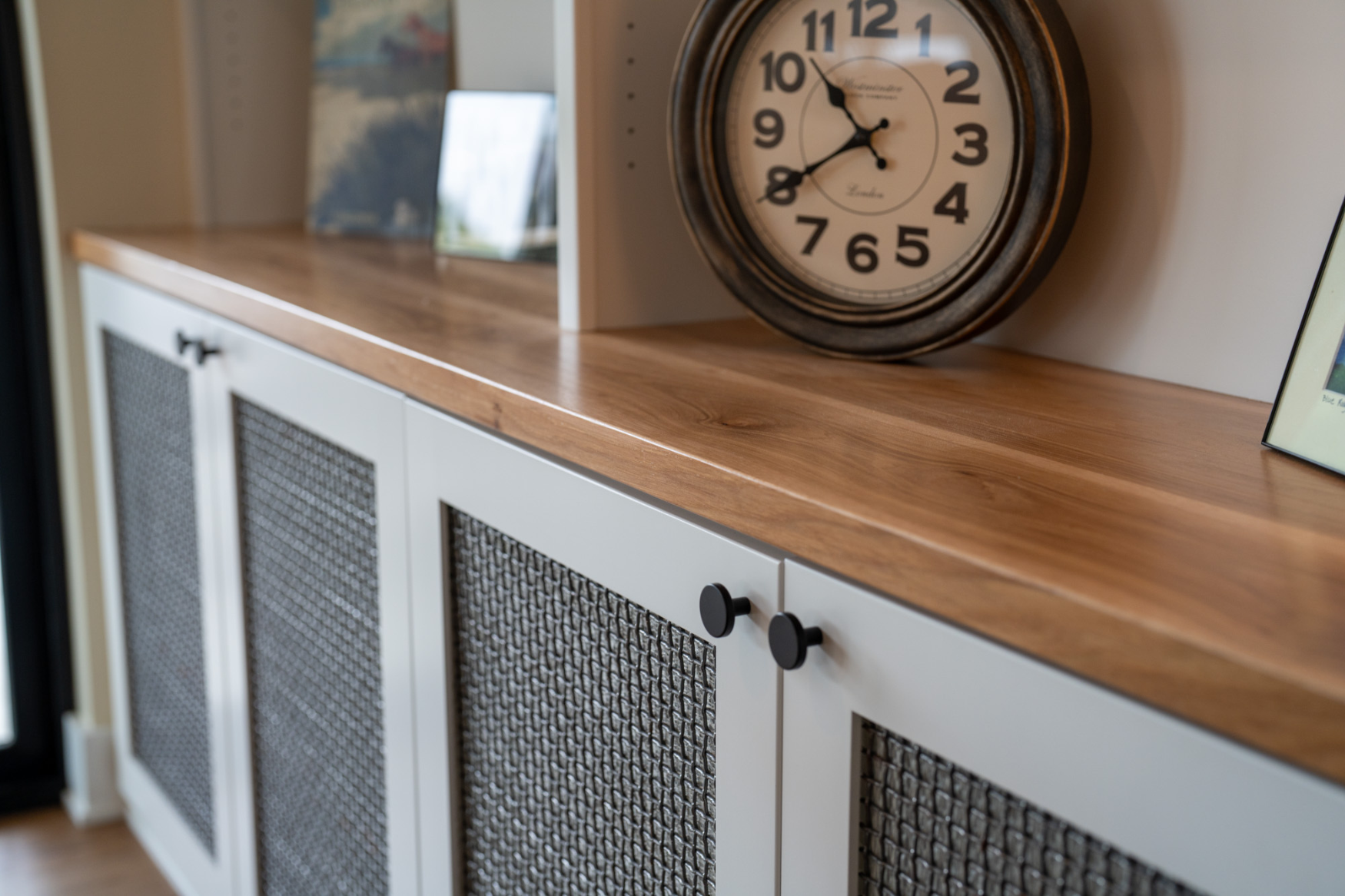 Built-in custom cabinetry with sleek wood countertops, highlighting high-quality craftsmanship in Hartland custom home design.