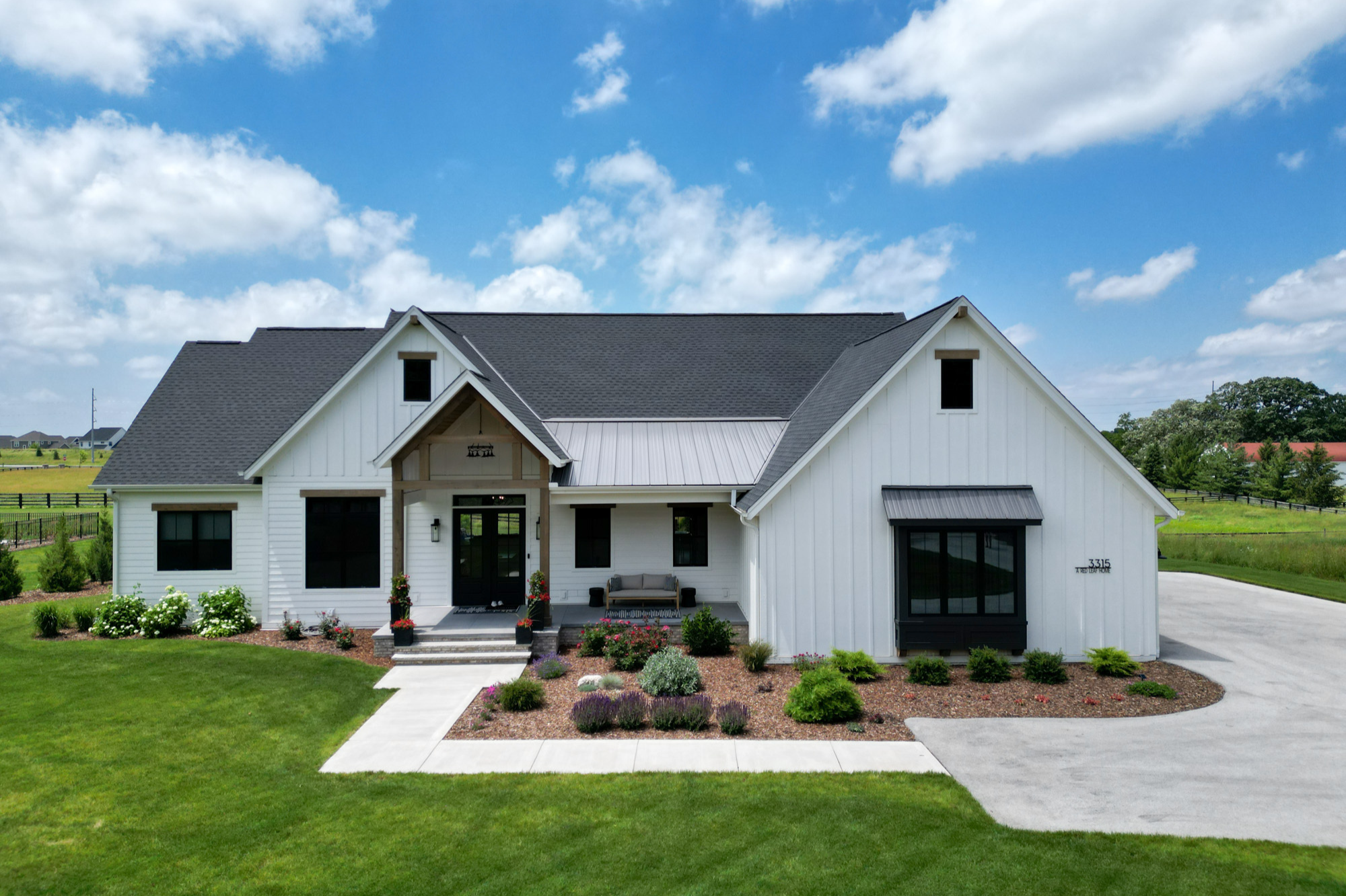 A modern farmhouse-style custom home in Hartland, emphasizing design features that can reveal hidden costs in custom home building.