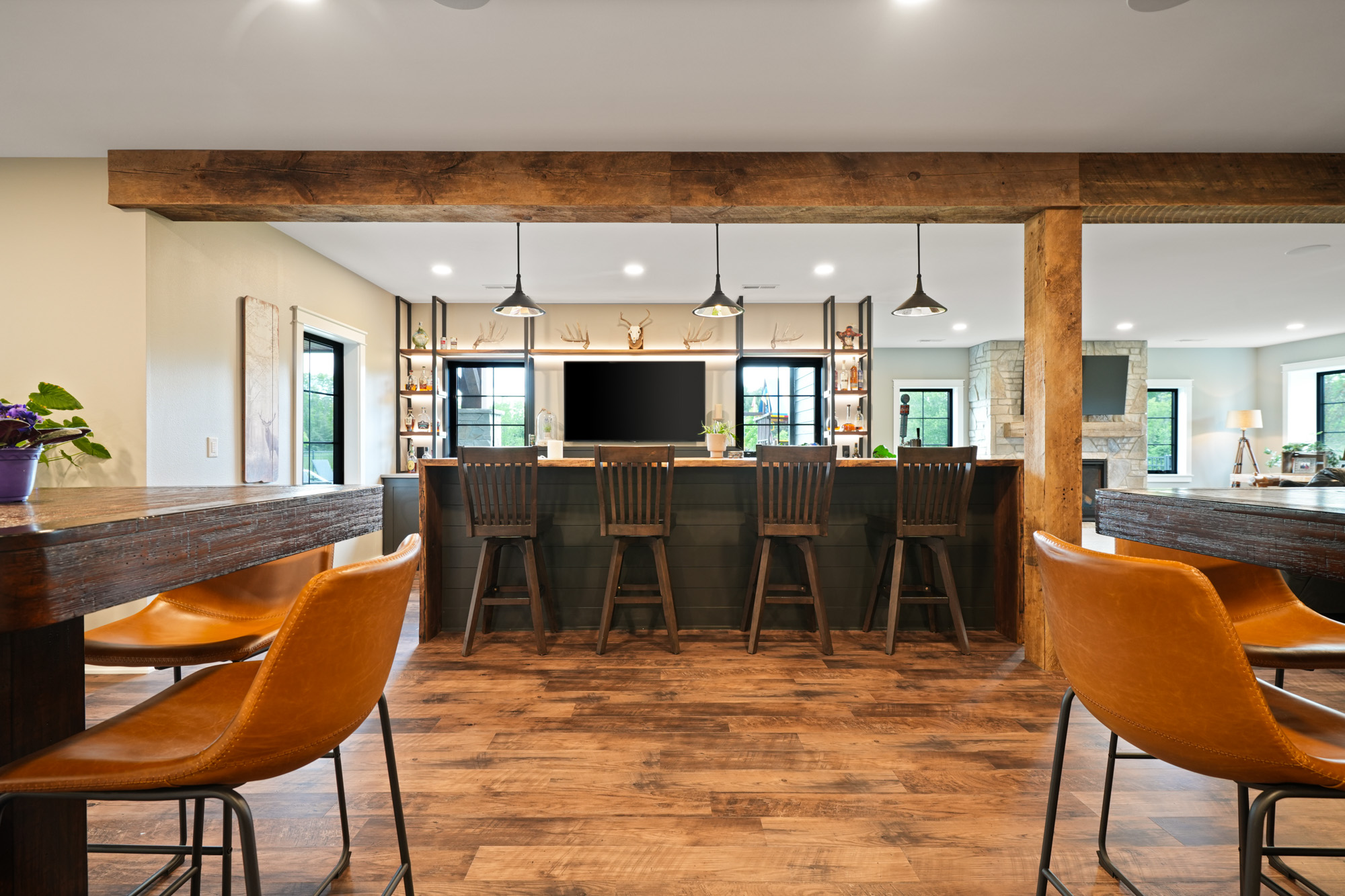 a custom bar in the basement designed by Home Builders Chenequa WI. in overcast light, a beautiful custom home designed by redleaf homes