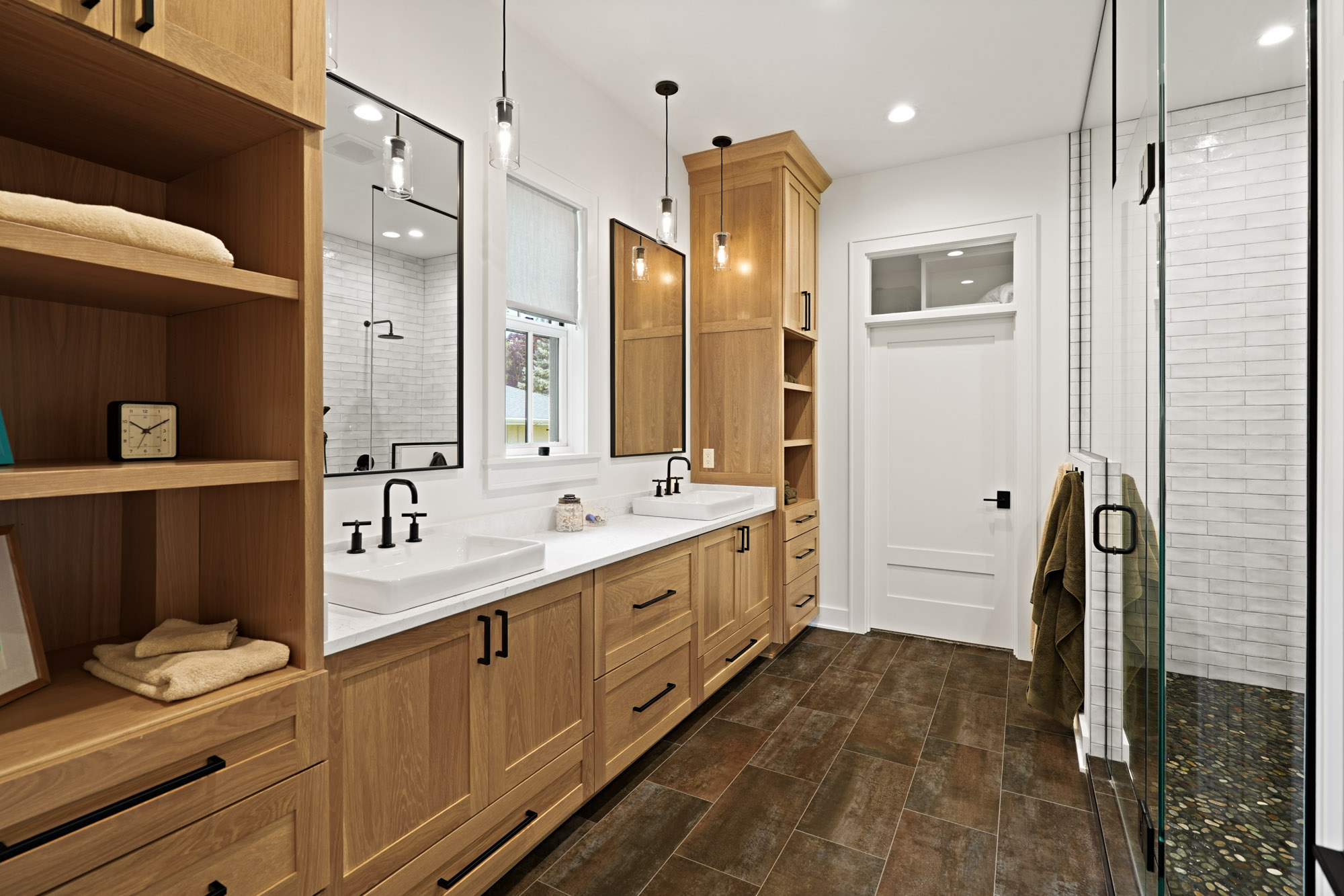 Camera1_92 Modern bathroom featuring double vanity with natural wood cabinetry and a glass-enclosed shower, built by Brookfield WI custom home builders.