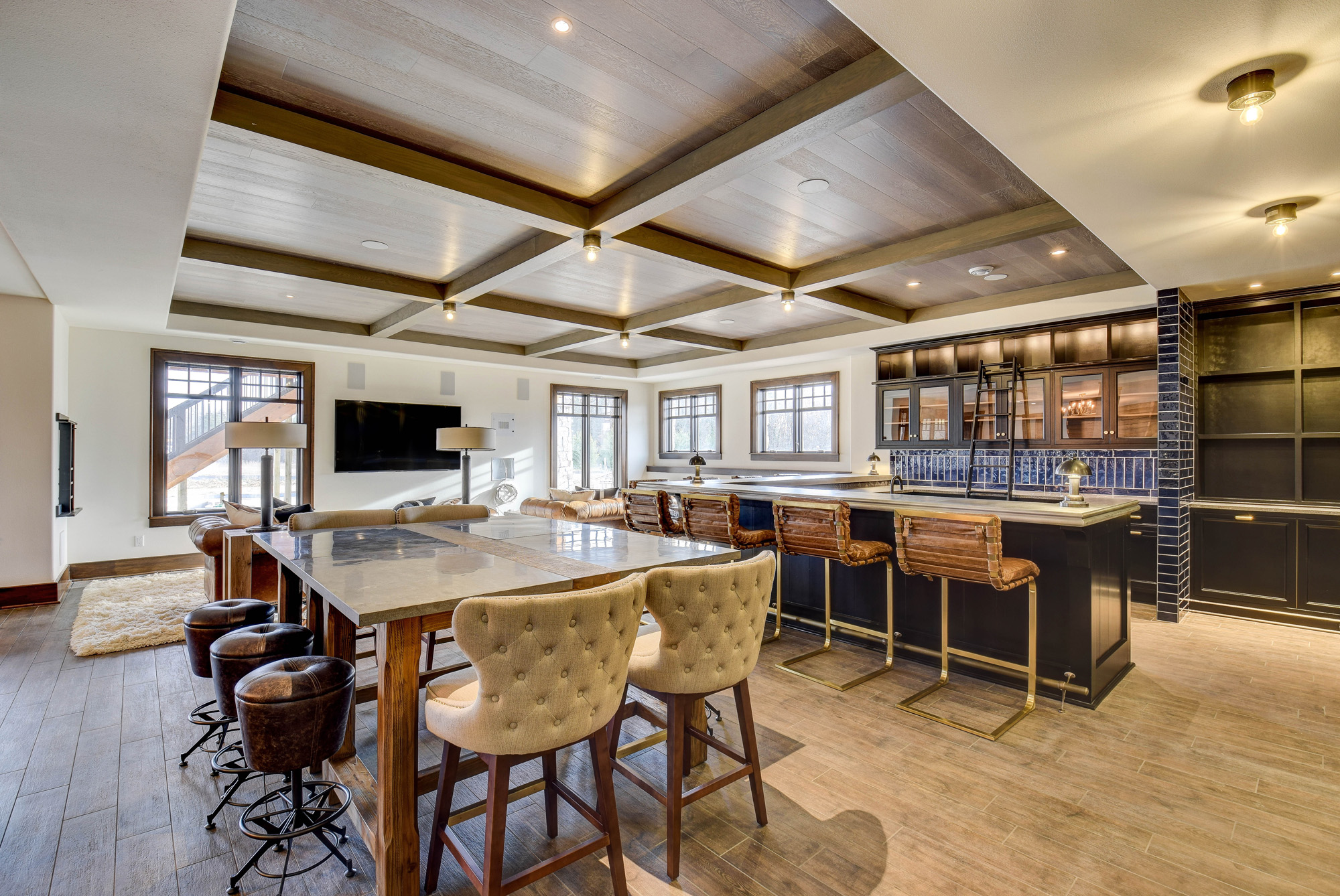 DSC_0326_27_28_29_30 Elegant lower-level entertainment space with coffered ceilings, custom bar, and high-end finishes designed by Brookfield WI custom home builders.